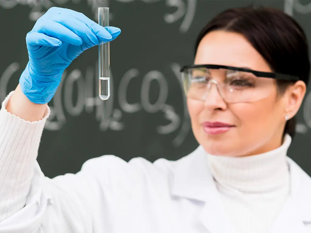 Female scientist examining a laboratory test tube for longevity and beauty research